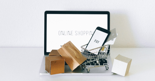 Online shopping on a computer with shopping cart and boxes