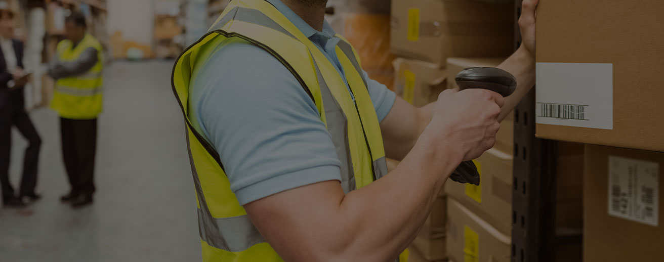 Man in warehouse scanning Lot number on box